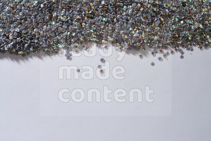 Multicolored flat sequins on grey background