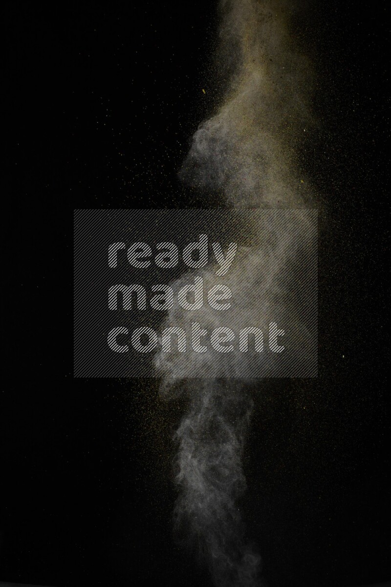 A side view of brown powder explosion on black background