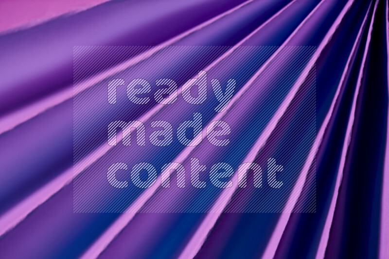 An image presenting an abstract paper pattern of lines in purple tones