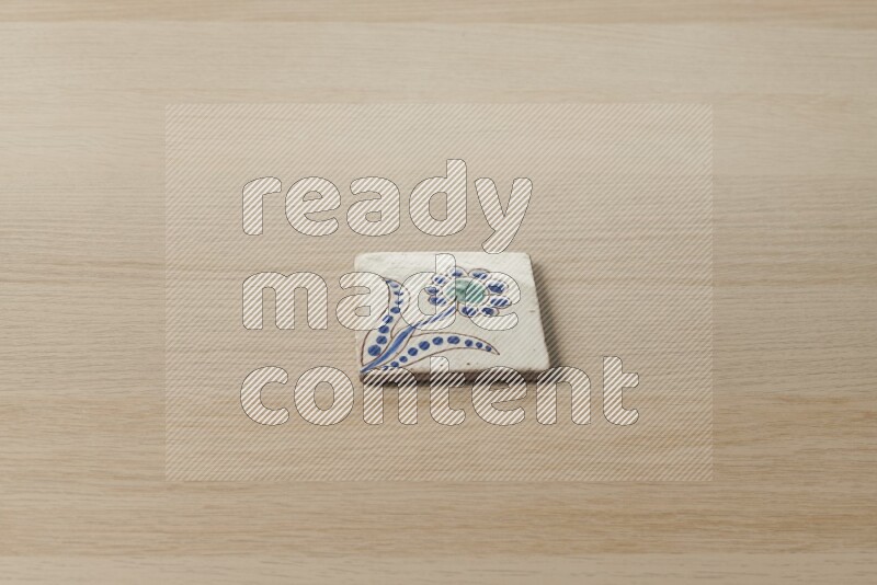A decorative coaster on light wooden background