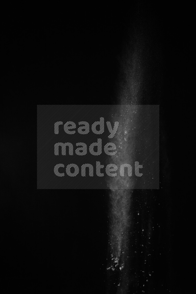 A side view of white powder explosion on black background