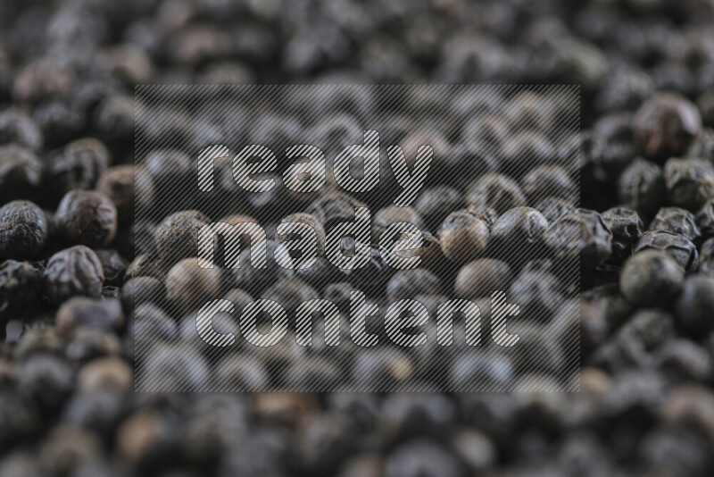 Black pepper beads on white background