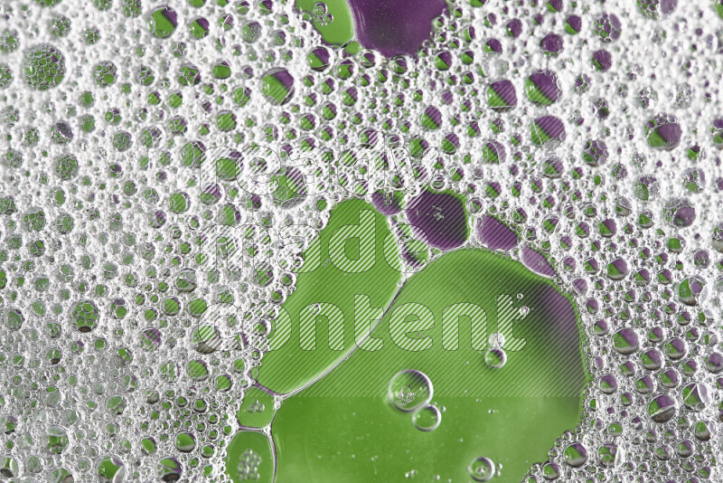 Close-ups of abstract soap bubbles and water droplets on green and purple background
