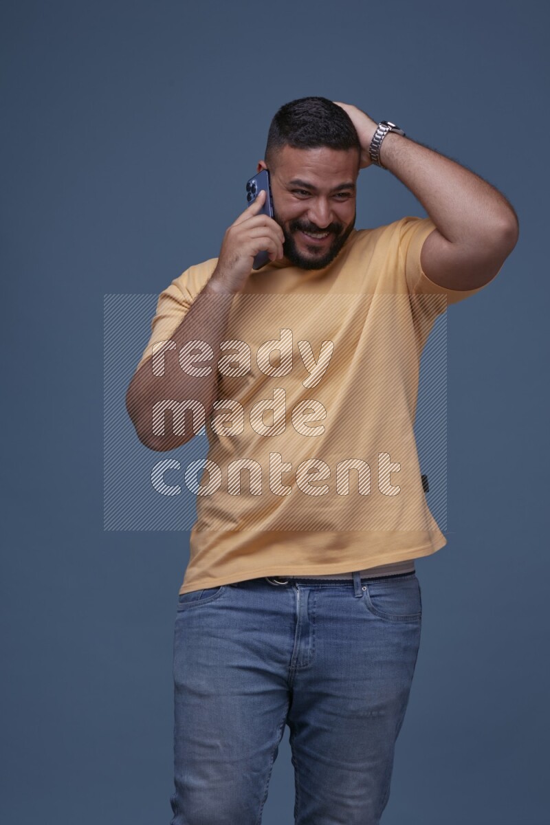 A man Calling on Blue Background wearing Orange T-shirt