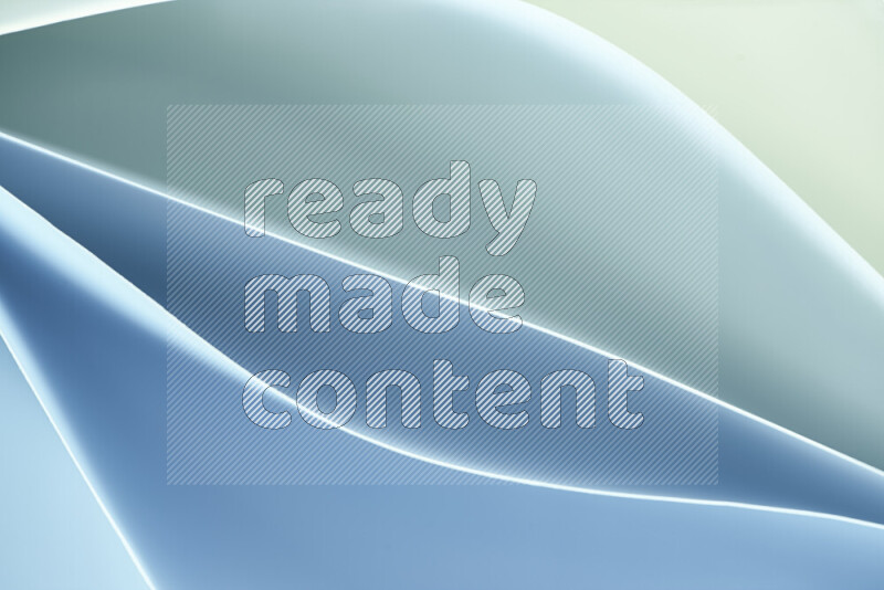 This image showcases an abstract paper art composition with paper curves in green and blue gradients created by colored light