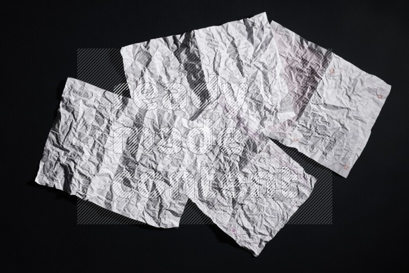 Crumpled notebook sheet on black background