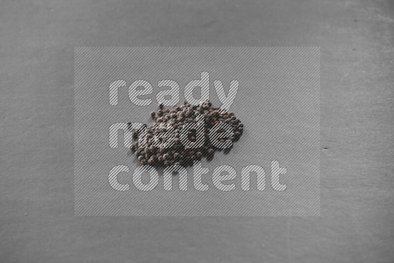 Black pepper on a black flooring