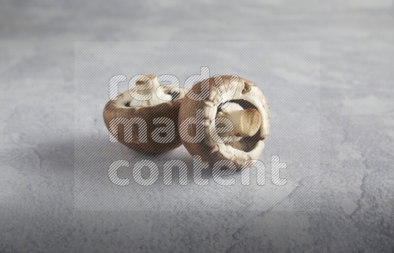 45 degre cremini  mushrooms on a textured light blue background