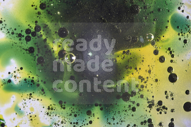 Close-ups of abstract yellow, blue and green watercolor drops on oil Surface on white background