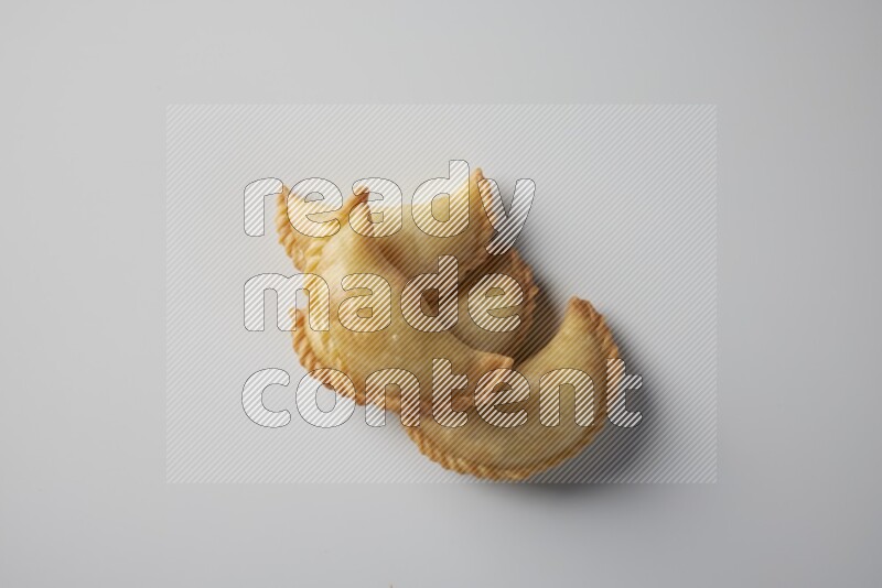 Four fried sambosa from a top angle on a white background