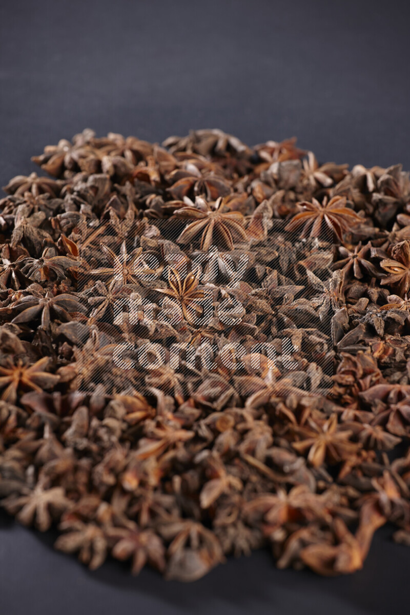 Star Anise fill the frame on black flooring