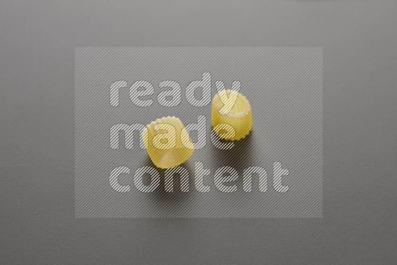 Big rings pasta on grey background