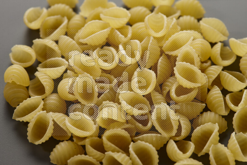 Shells pasta on grey background