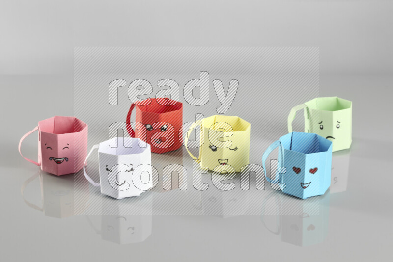 Origami cup on grey background