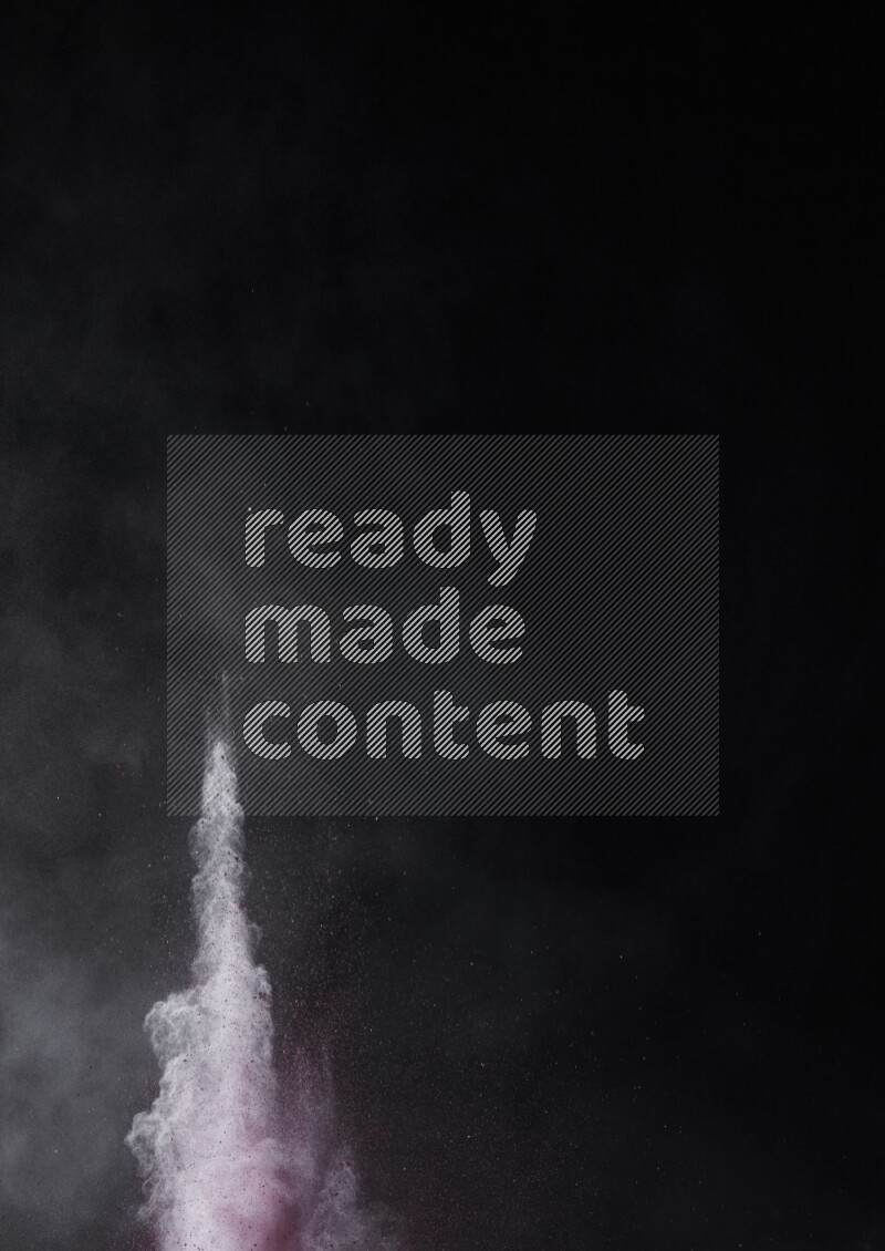 A side view of red powder explosion on black background