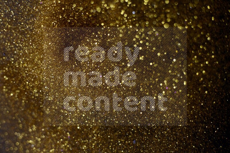 Gold glitter powder isolated on black background