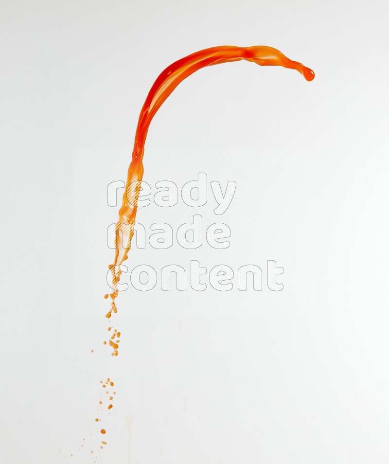 Orange liquid splash and drops on white background