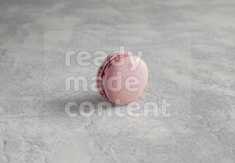 45º Shot of Purple Strawberry macaron on white  marble background
