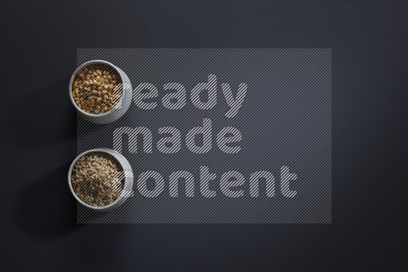 Legumes in pottery bowls on grey background