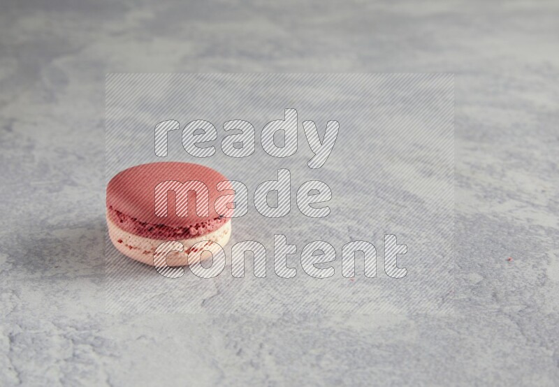 45º Shot of Pink Litchi Raspberry macaron on white  marble background