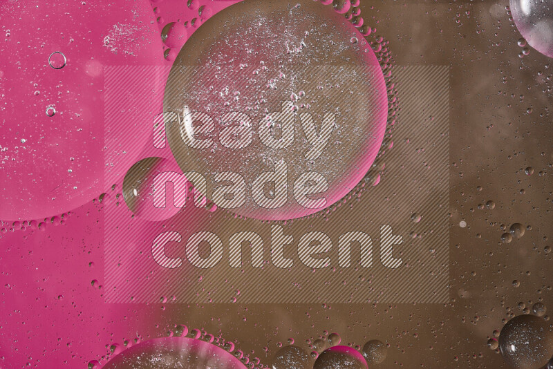 Close-ups of abstract oil bubbles on water surface in shades of pink and brown