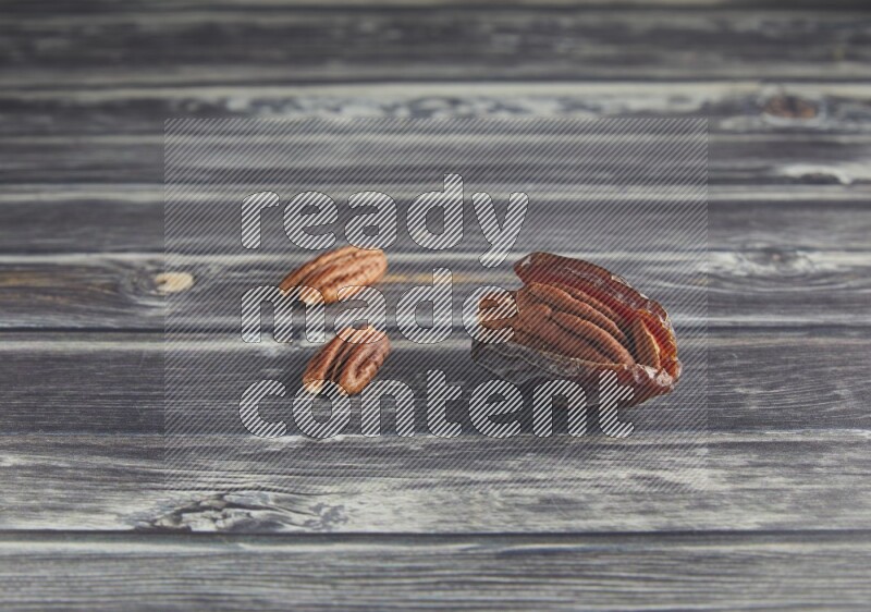 pecan stuffed madjoul date on a wooden grey background