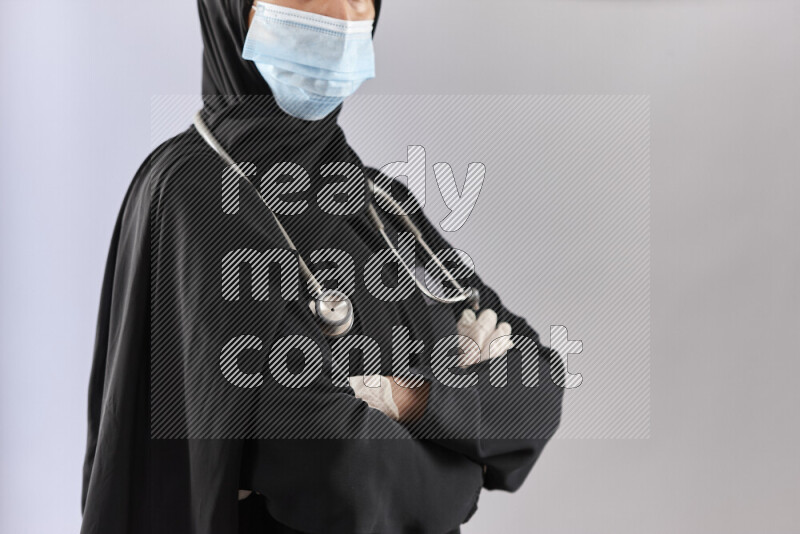 Female doctor wearing an abaya and medical attire in different positions