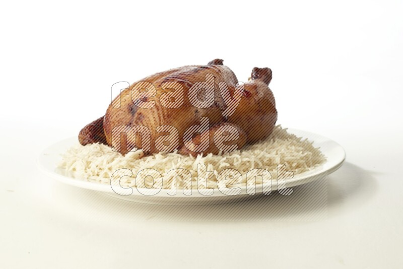 white  basmati Rice with  whole roasted chicken  on a white rounded plate direct on white background