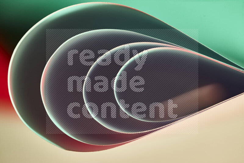 An abstract art of paper folded into smooth curves in green and red gradients