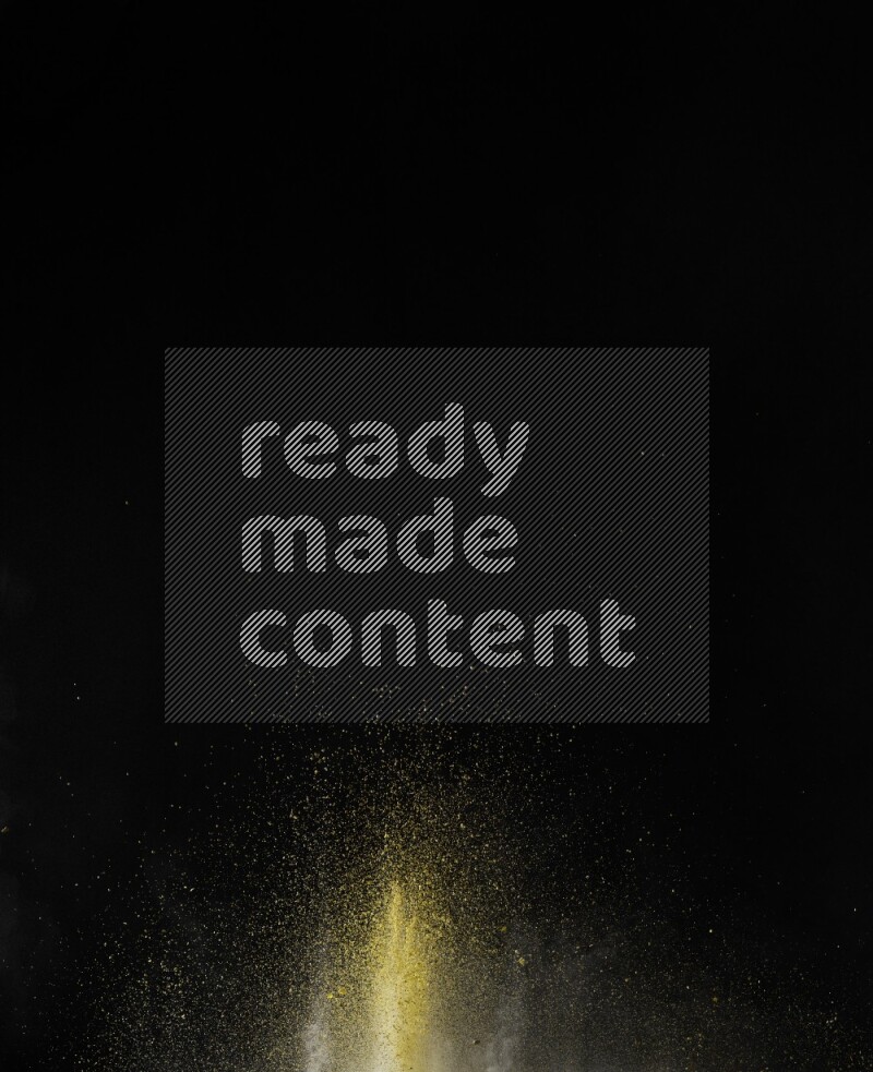 A side view of yellow powder explosion on black background