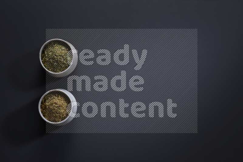 Legumes in pottery bowls on grey background