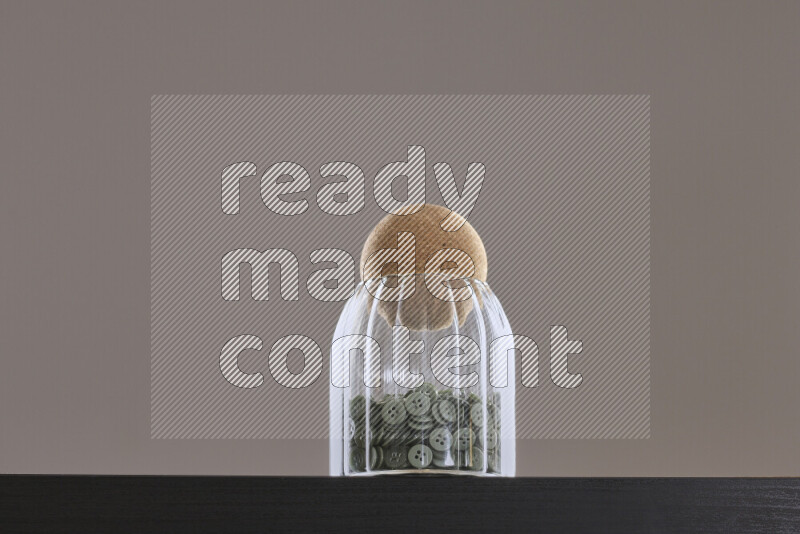 Buttons in a glass jar on black background