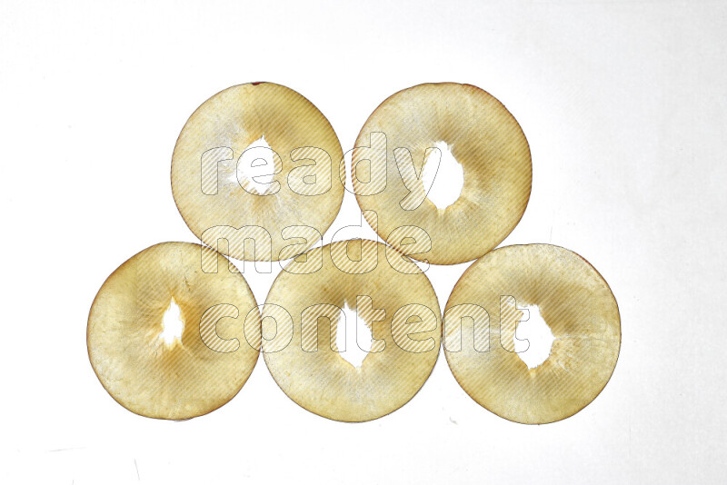 Peach slices on illuminated white background