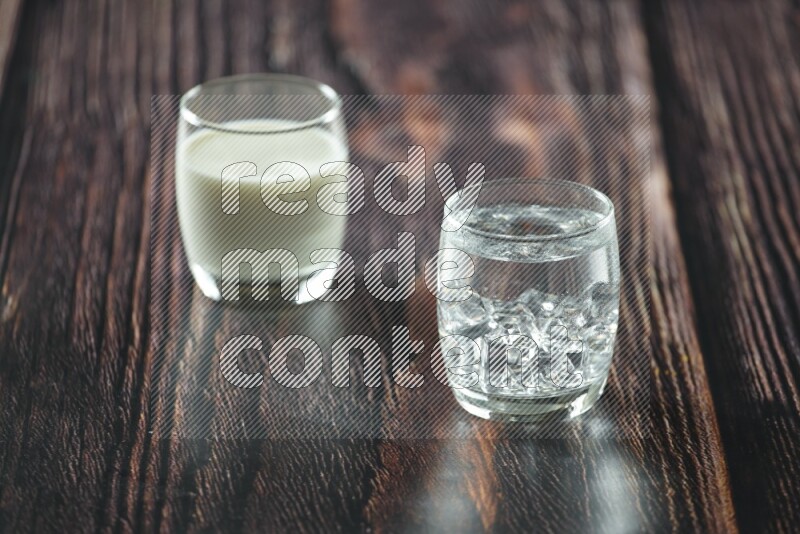 Cold drinks in a glass cup such as water, tamarind, qamar eldin, sobia, milk and hibiscus on wooden background