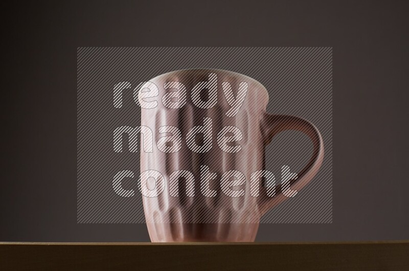 Low angle shot of a pink cup on grey background