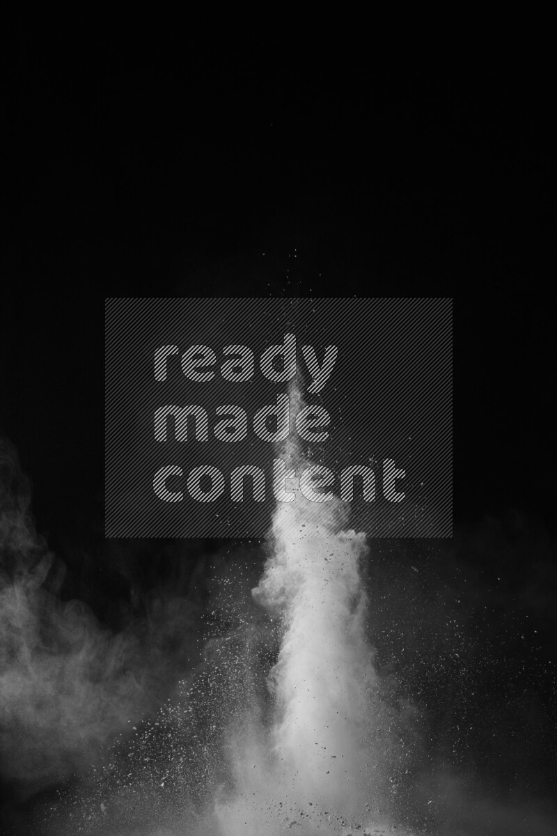 A side view of white powder explosion on black background