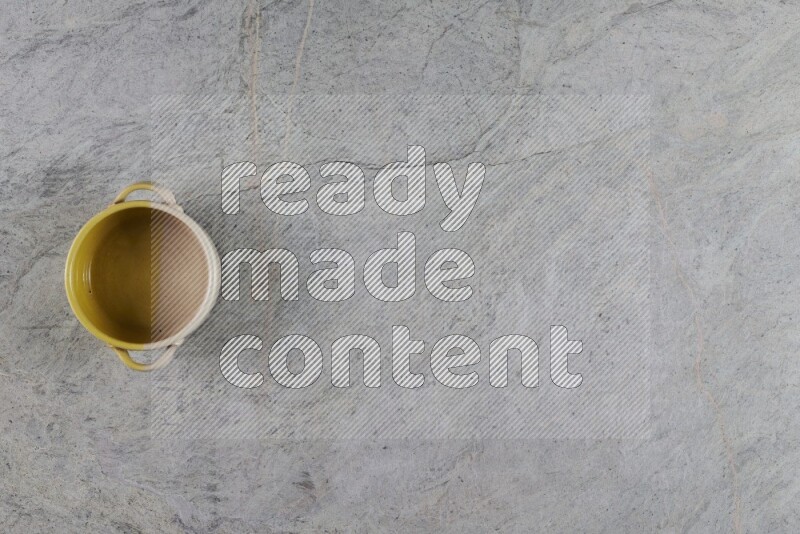 A multicolored pottery Bowl on grey marble background
