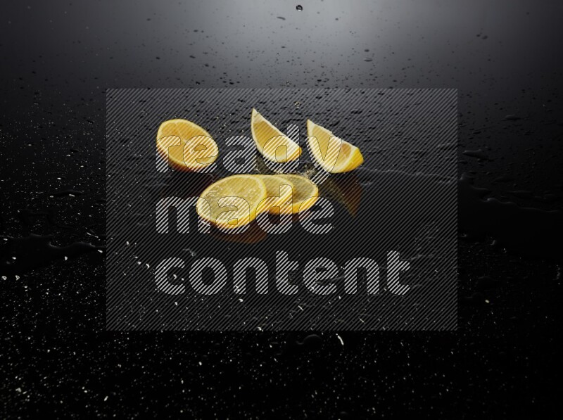 Lemon slices with water drops, and droplets on black background