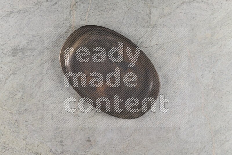 A vintage metal tray on grey marble background