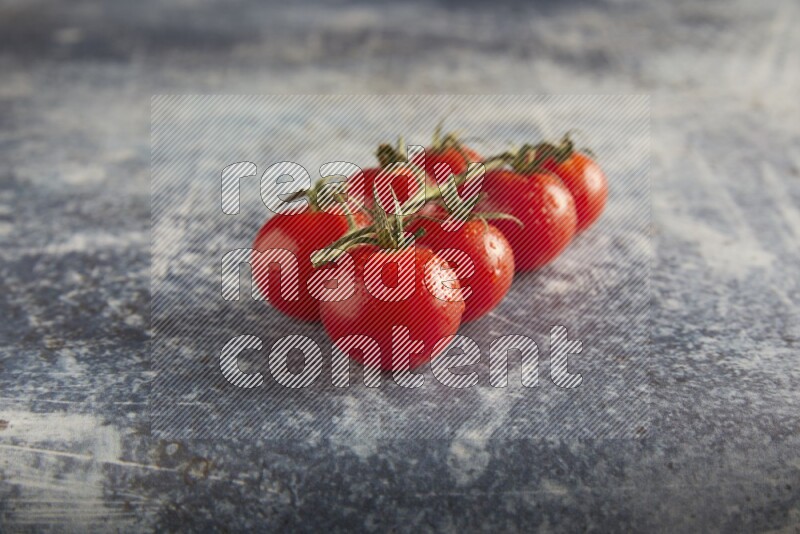 Red cherry tomato vein on a textured rusty blue background 45 degree