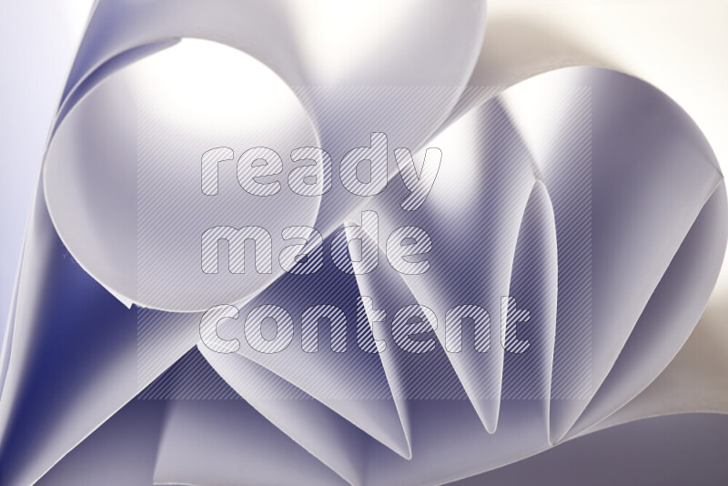 An artistic display of paper folds creating a harmonious blend of geometric shapes, highlighted by soft lighting in grey