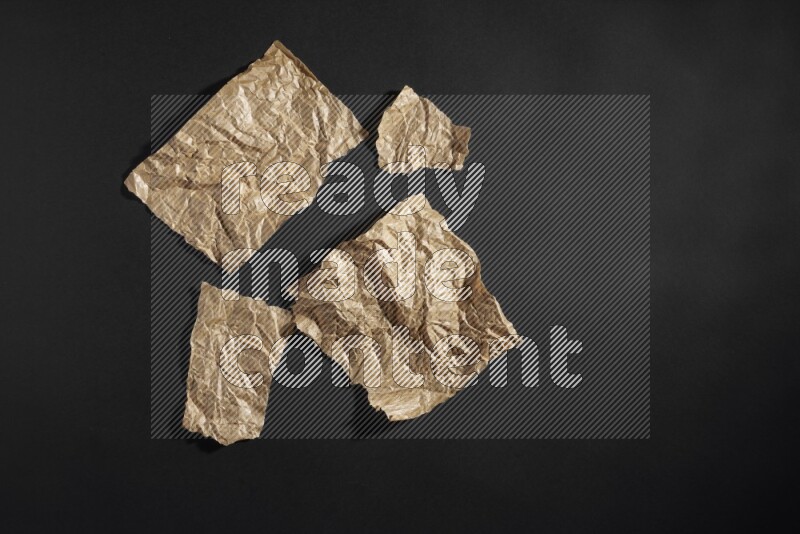 Crumpled craft paper on black background
