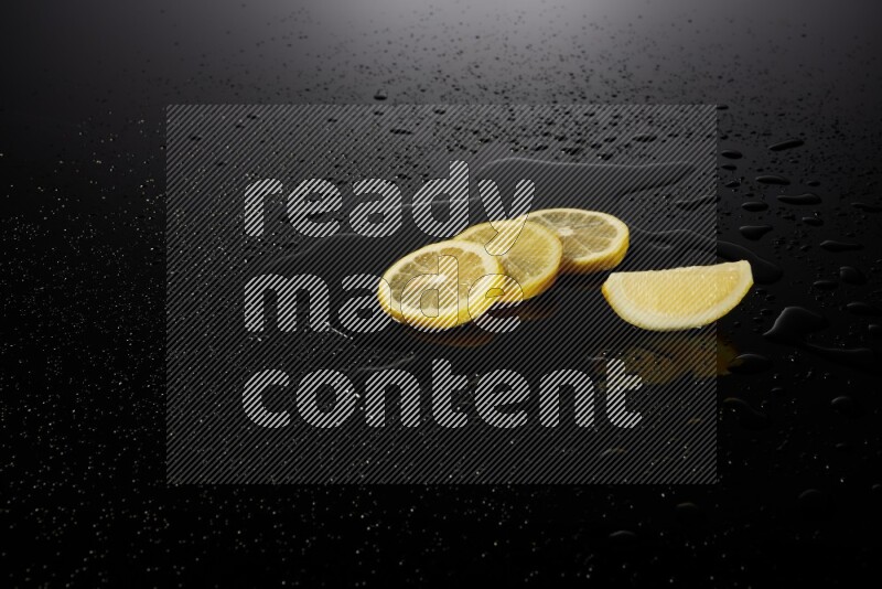 Lemon slices with water drops, and droplets on black background