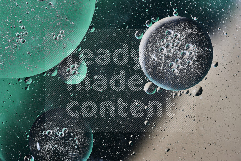 Close-ups of abstract oil bubbles on water surface in shades of green and brown