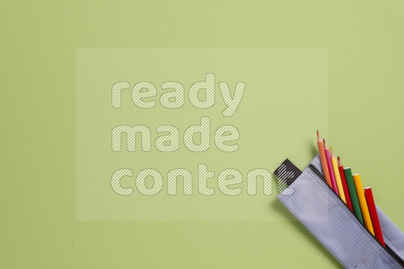 Different school supplies on green background