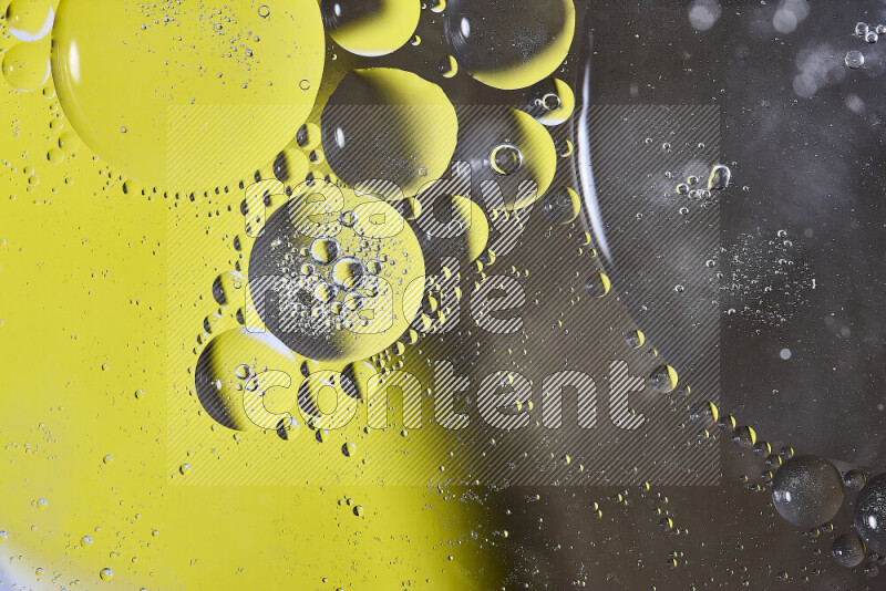 Close-ups of abstract oil bubbles on water surface in shades of yellow and brown