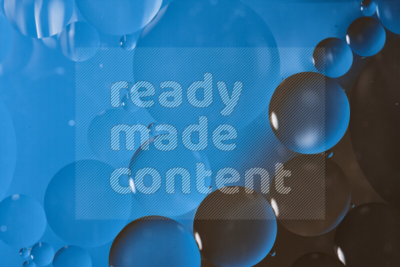 Close-ups of abstract oil bubbles on water surface in shades of blue and brown