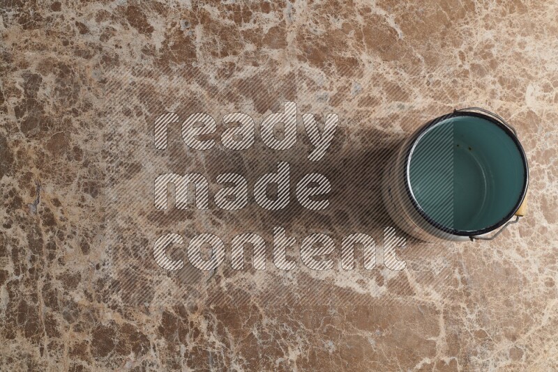 A vintage milk can on beige marble background