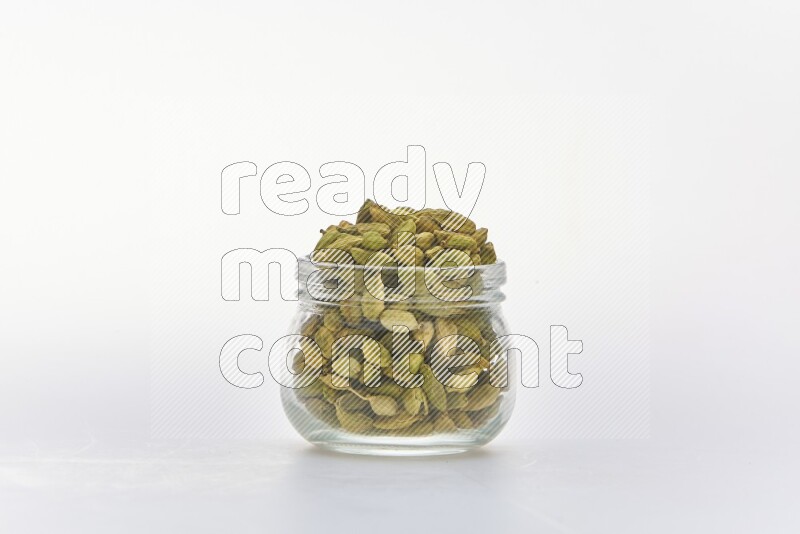 Cardamon in a container on white background