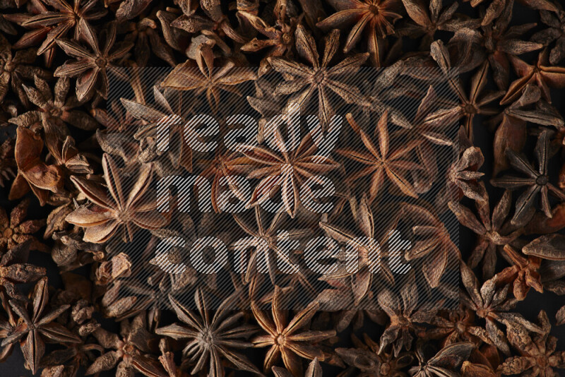 Star Anise fill the frame on black flooring